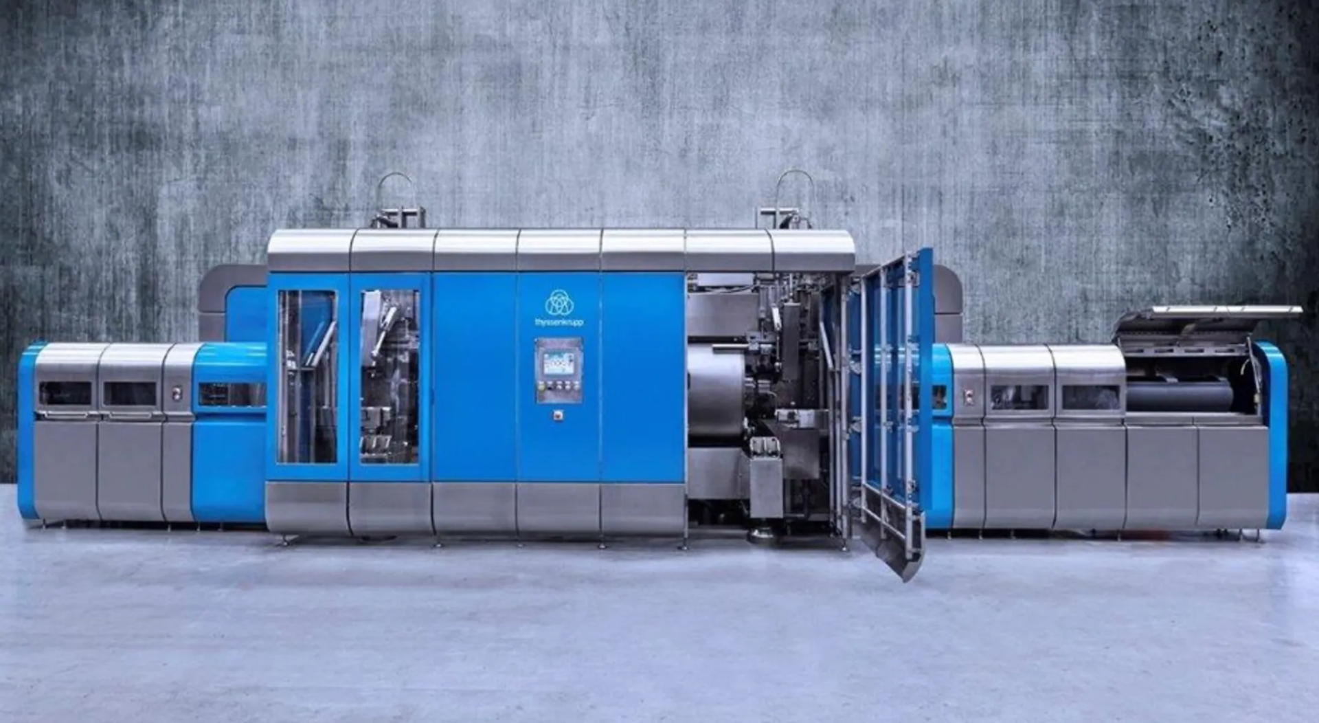 Large blue-and-gray thyssenkrupp industrial system for high-pressure food processing, with an open machine section in the center.