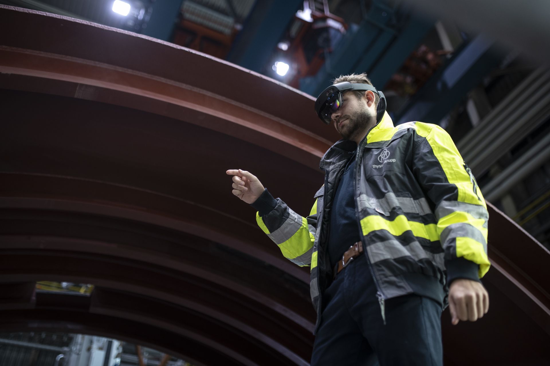 A thyssenkrupp employee uses augmented reality glasses to provide digital assistance during the inspection of an industrial component.