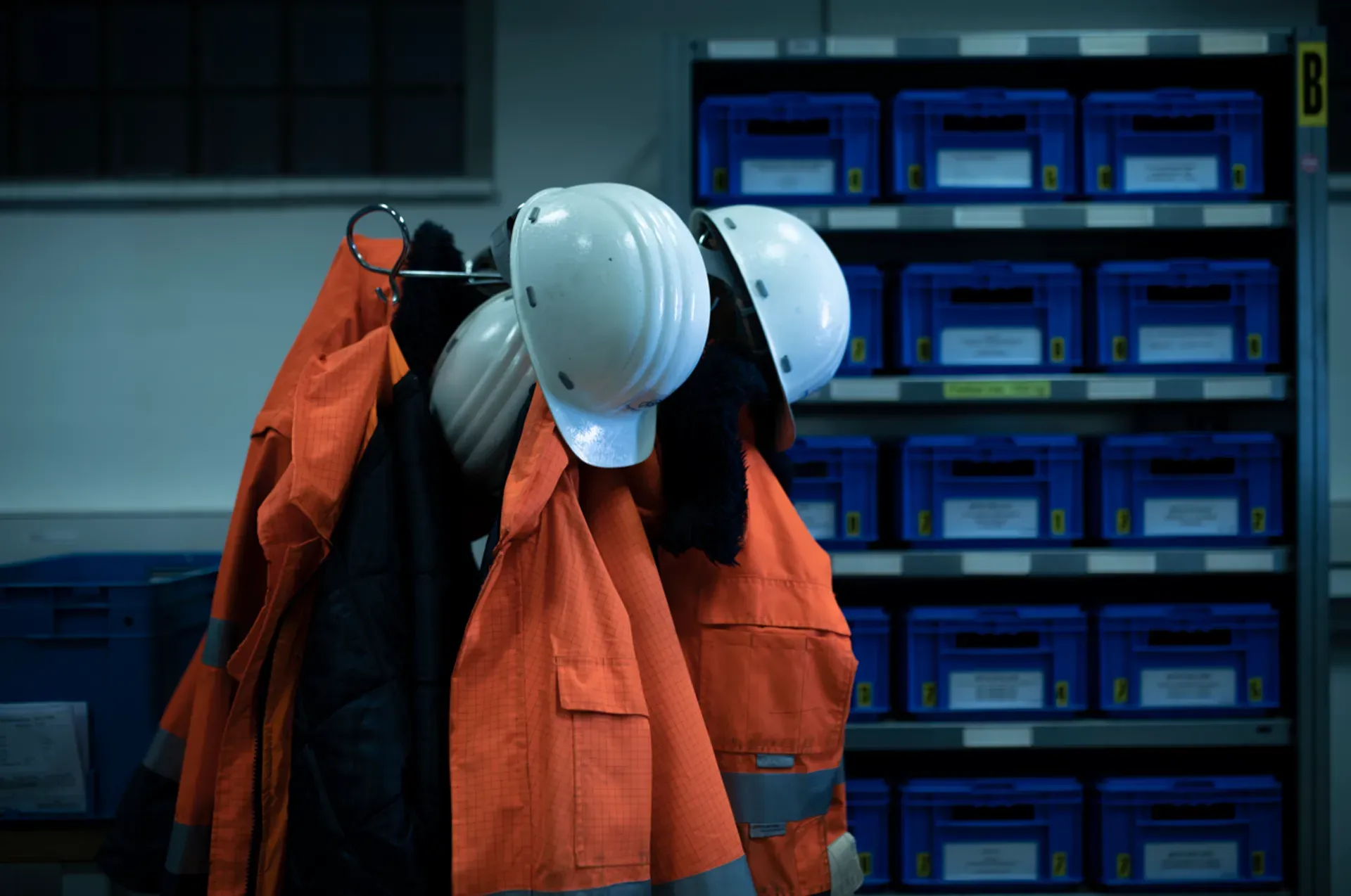 Protective helmets and safety clothing in an industrial workspace symbolizing employee protection and workplace standards