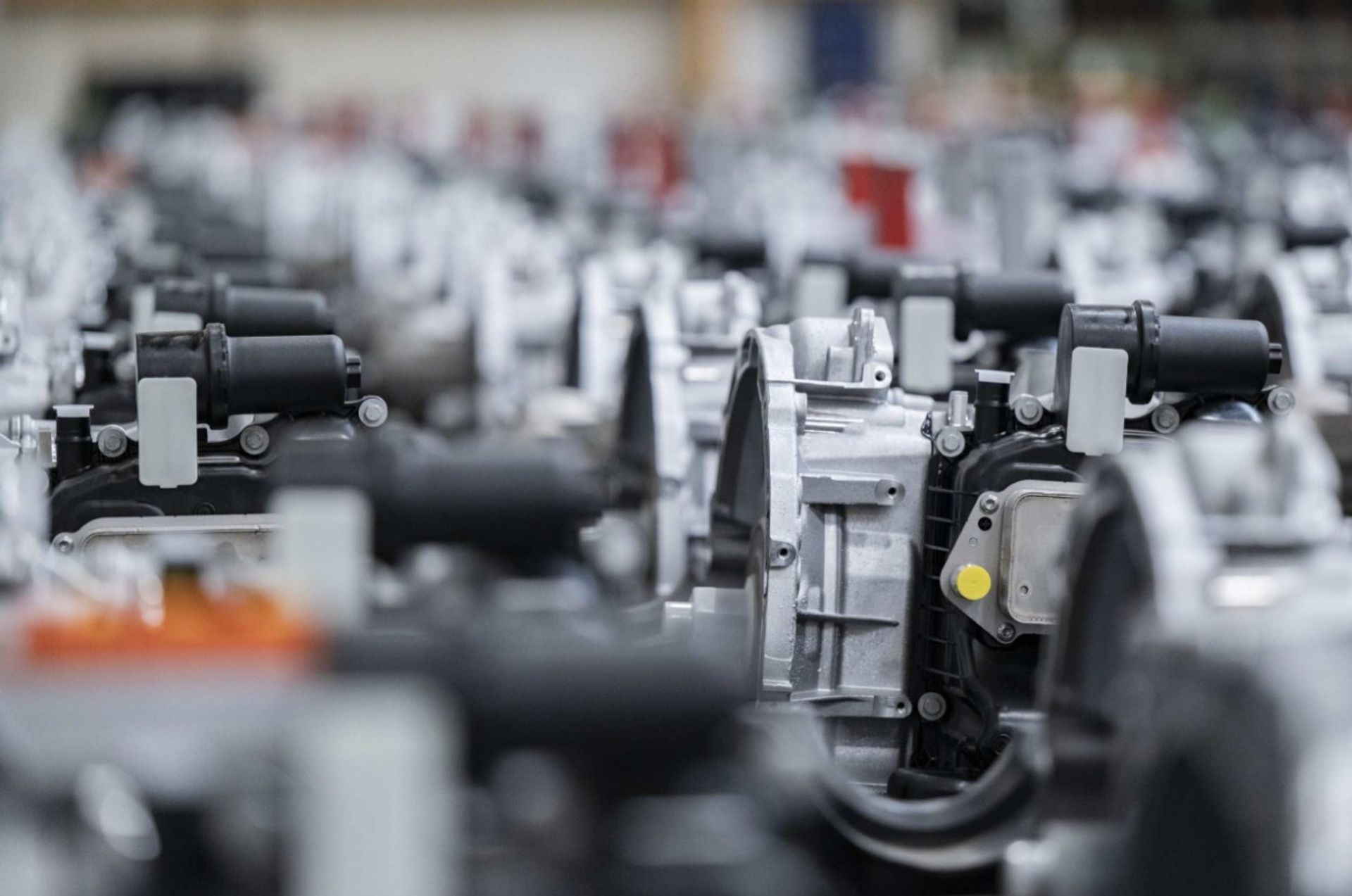 Rows of powertrain components for the automotive industry in a production hall.