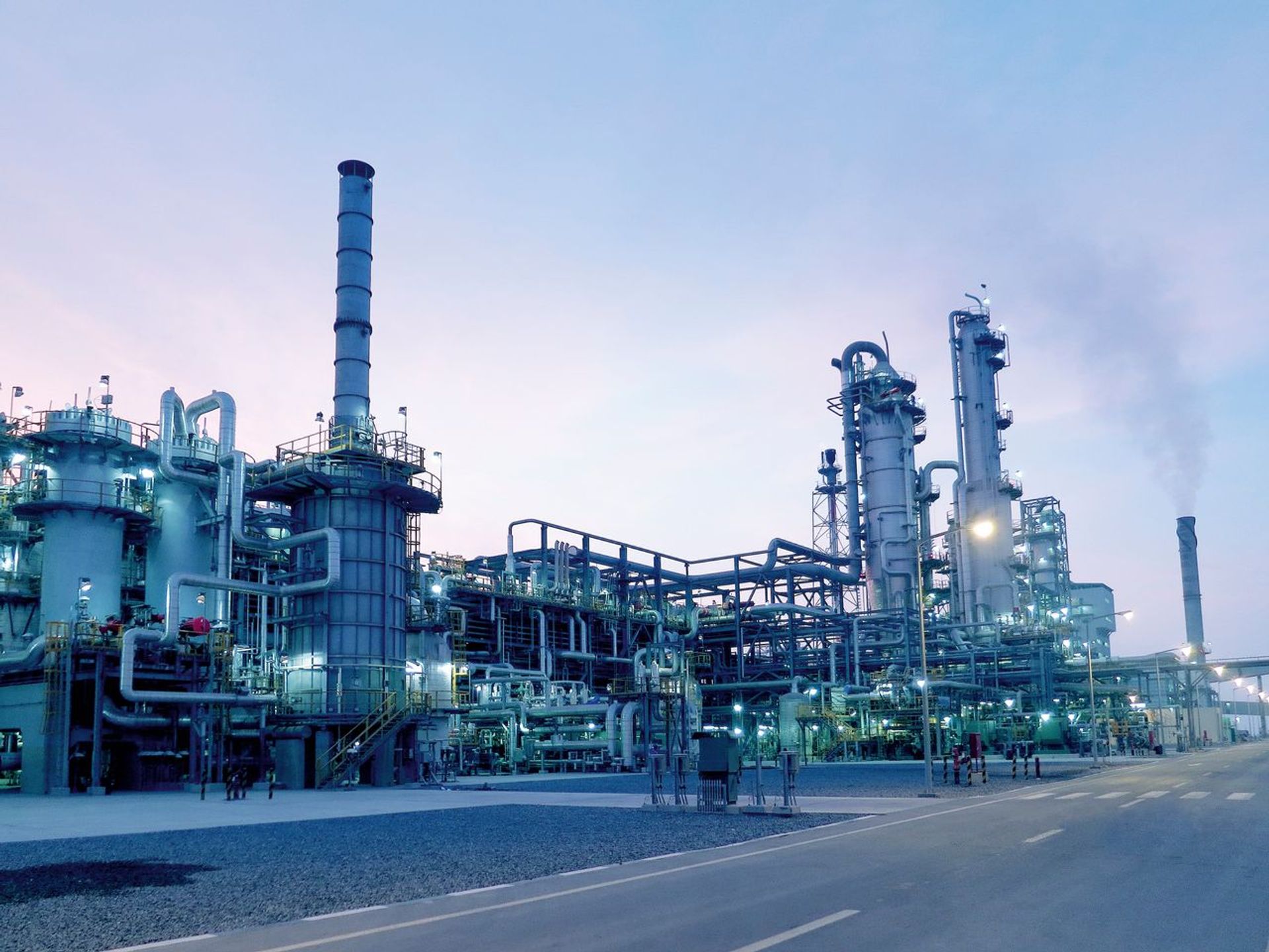 A large-scale industrial plant by thyssenkrupp Uhde, featuring piping, process columns, and smokestacks.