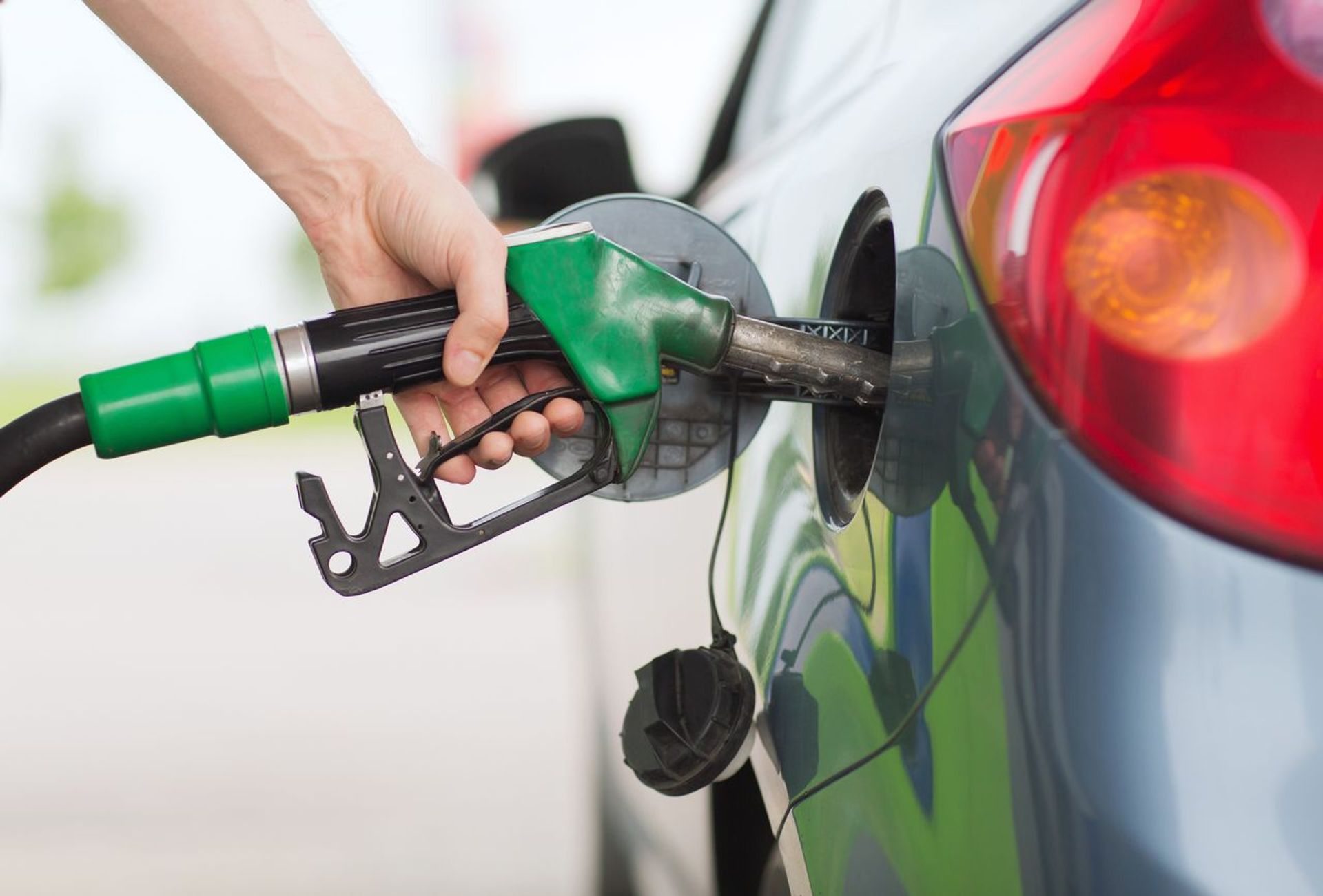 Fuel nozzle at a gas station symbolizing sustainable biofuels as an alternative to fossil fuels