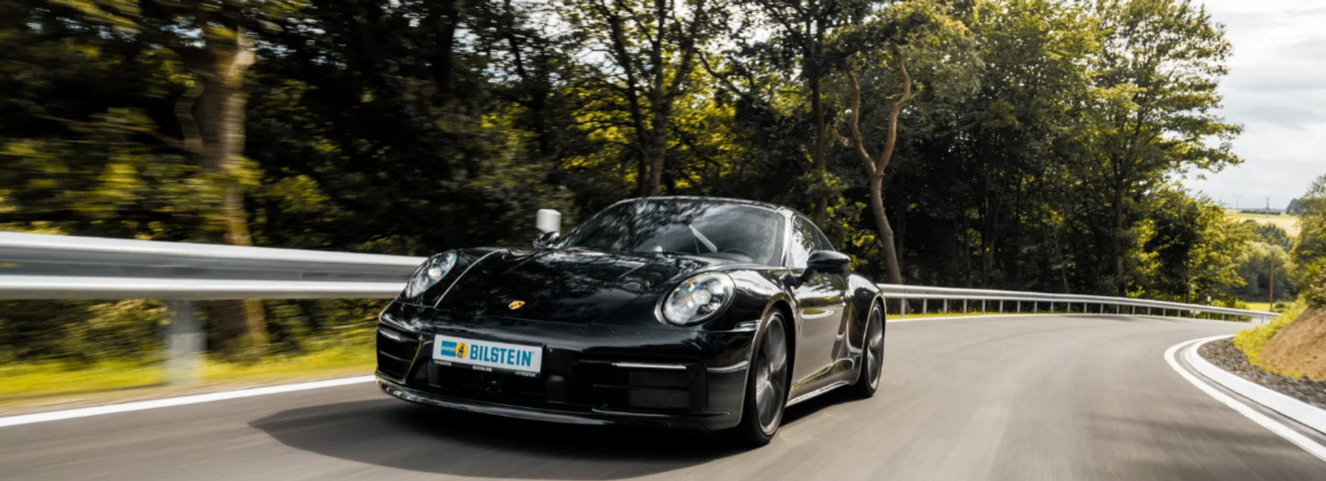 High performance sports car driving on curved road demonstrating improved handling and stability through semi active suspension system