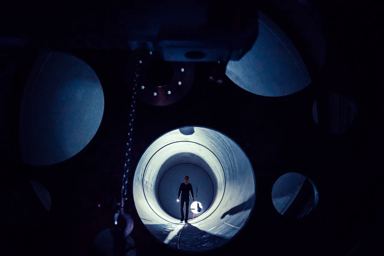 Mann mit einer Taschenlampe in einem Tunnel