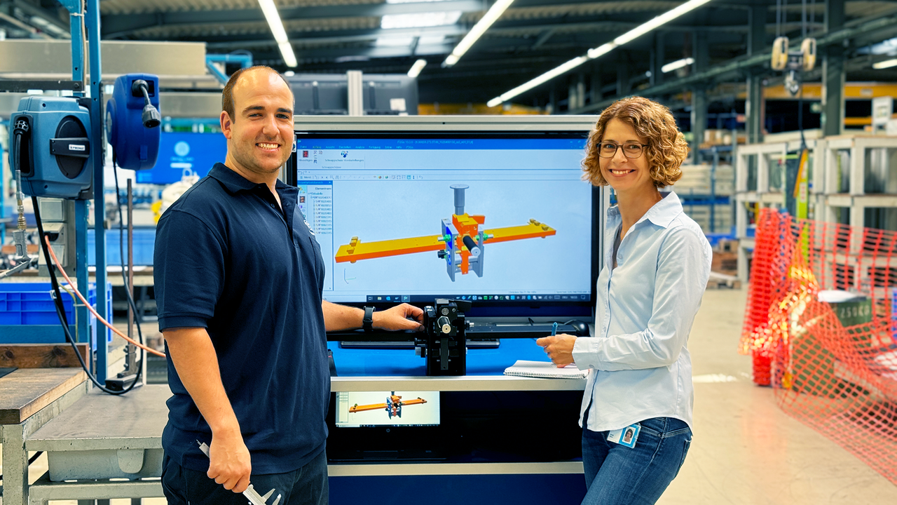Two colleagues from thyssenkrupp present a CAD drawing