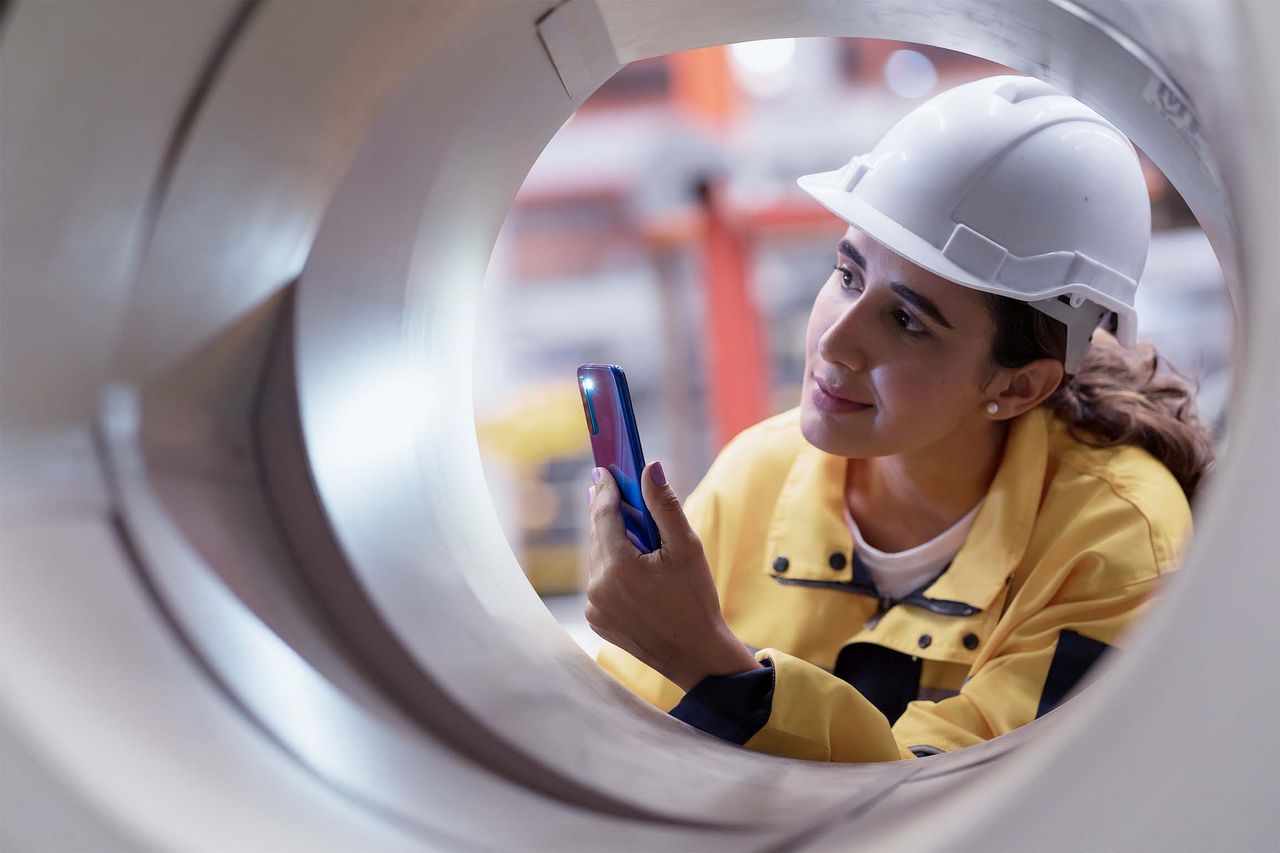 Quality manager inspecting coil in steel service center