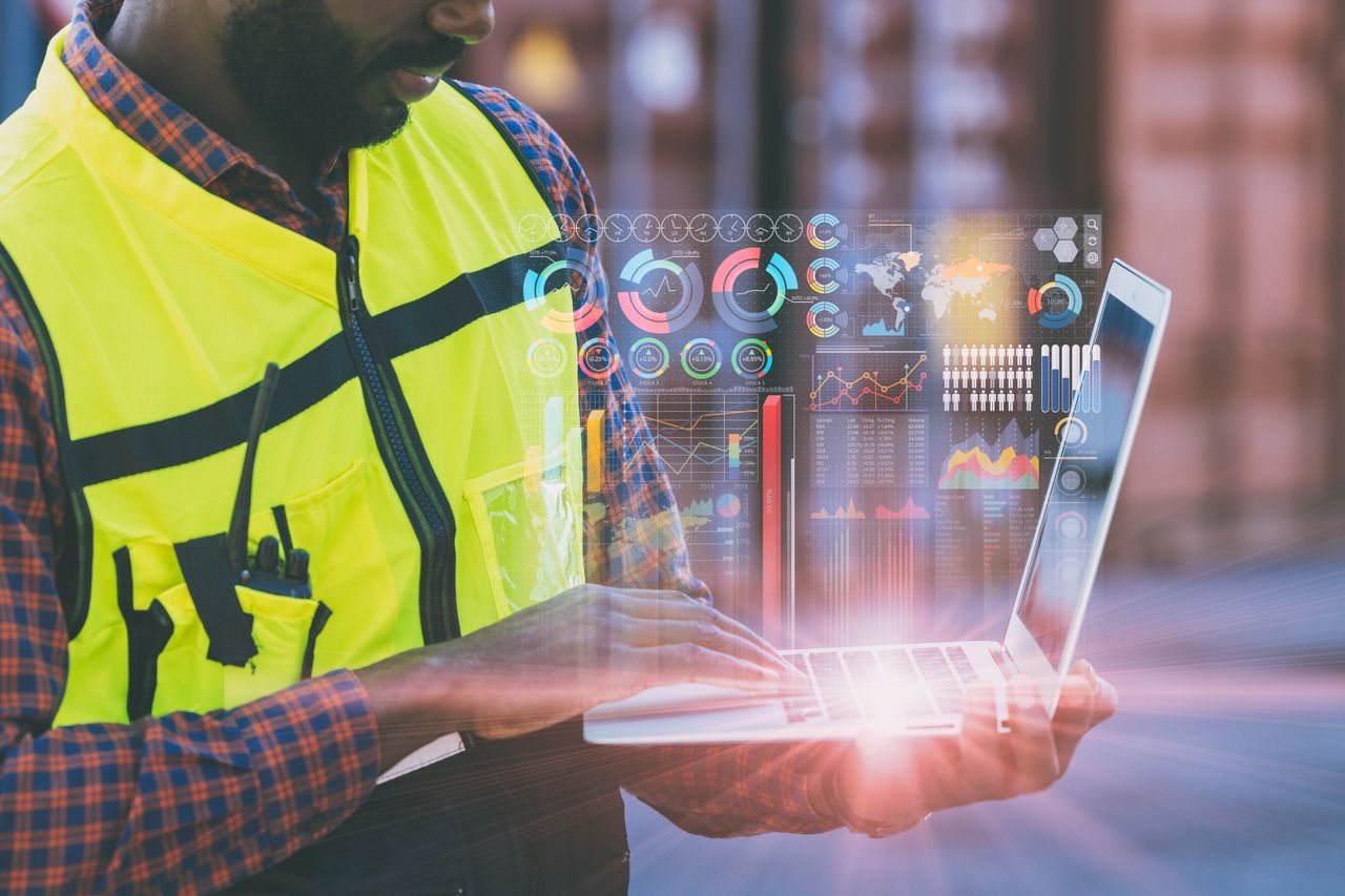 man using tablet to monitor operations in automotive OEM