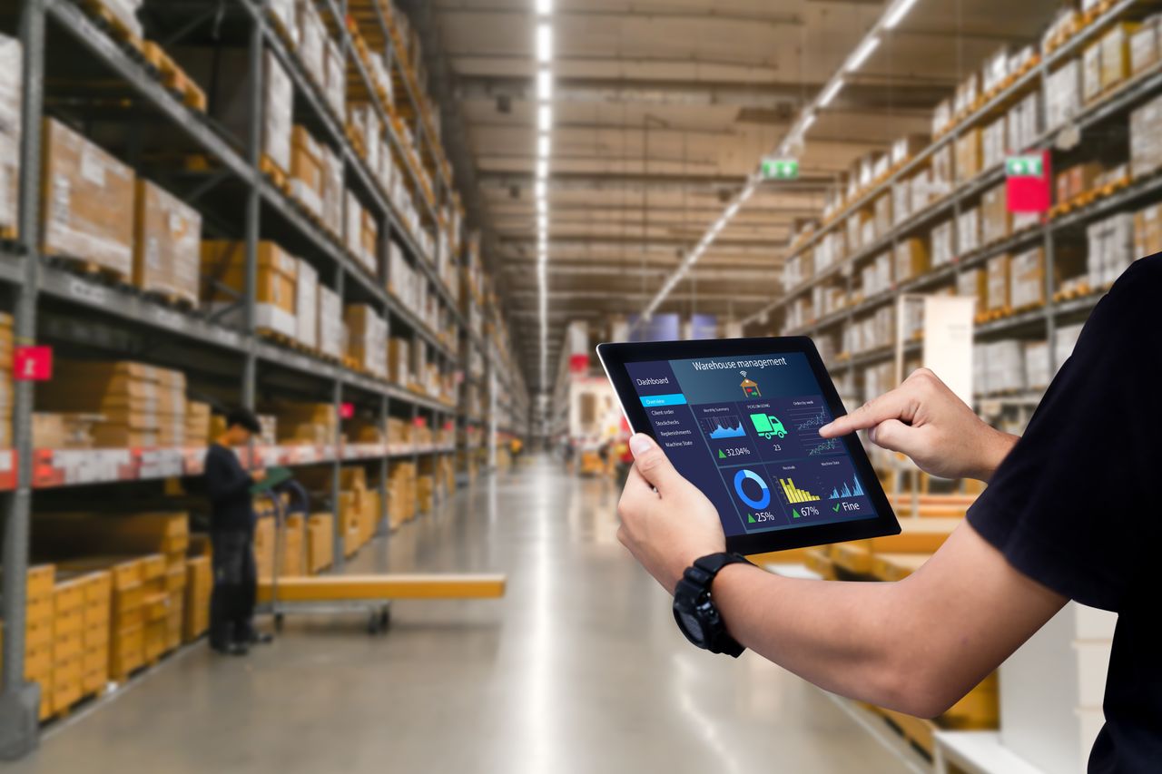 worker holding ipad to manage supply chain using digitalization to reduce waste