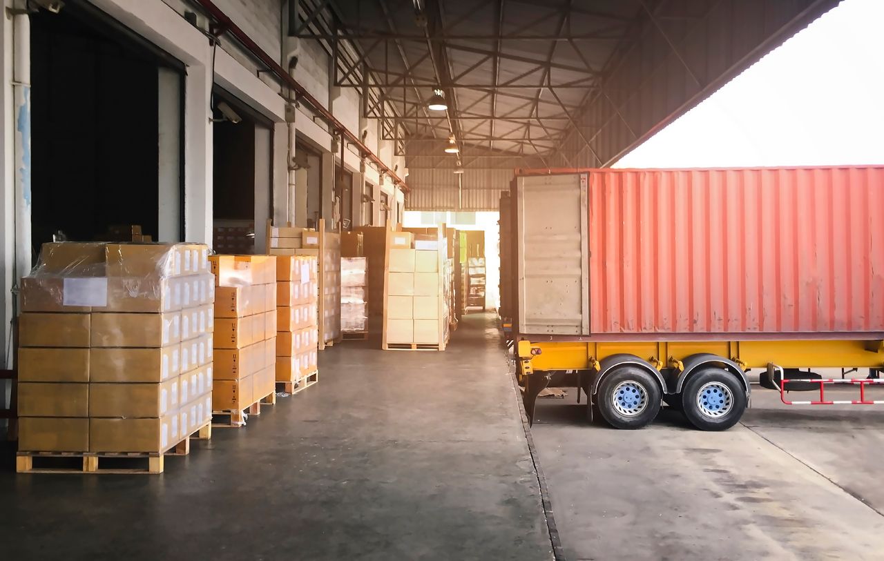 a semitruck completing a materials handling task by loading and unloading product for a customer