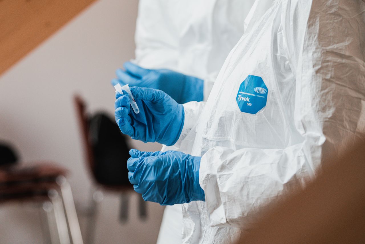 technician holding vials to perform a type of non destructive testing