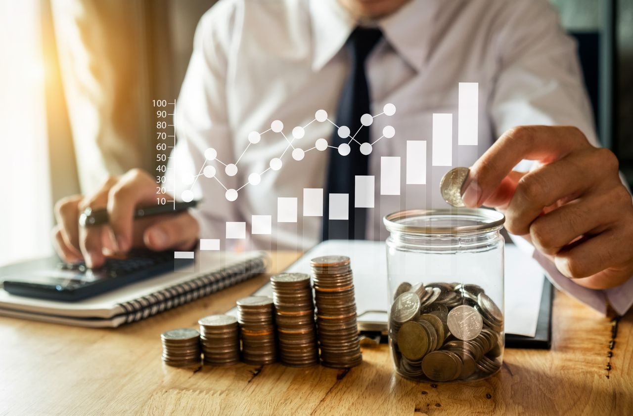 person counting coins with graphic overlay showing a bar graph with an arrow showing cost going up