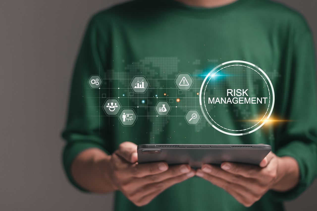 person using technology to assess risk management