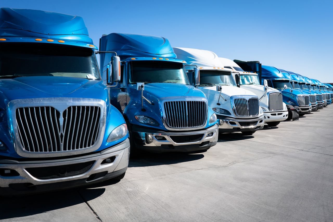 row of semitrucks used for transportation supply chain solutions