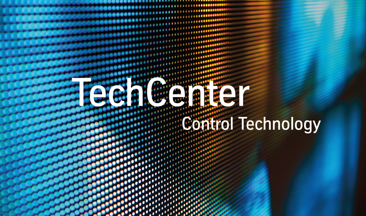 Screen with futuristic pixels showing the words TechCenter Control Technology in white writing