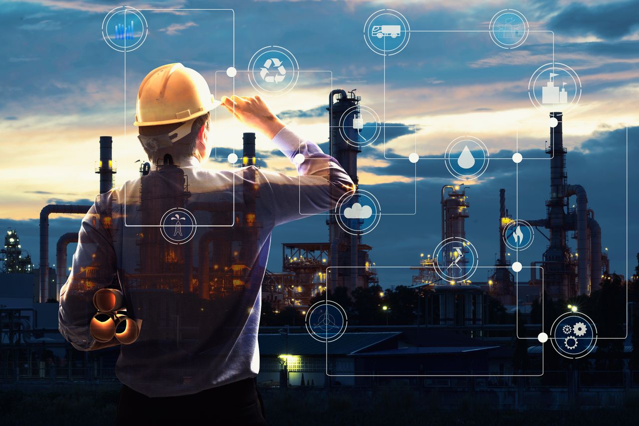 Person with construction helmet thoroughly analyses a complex industrial environment